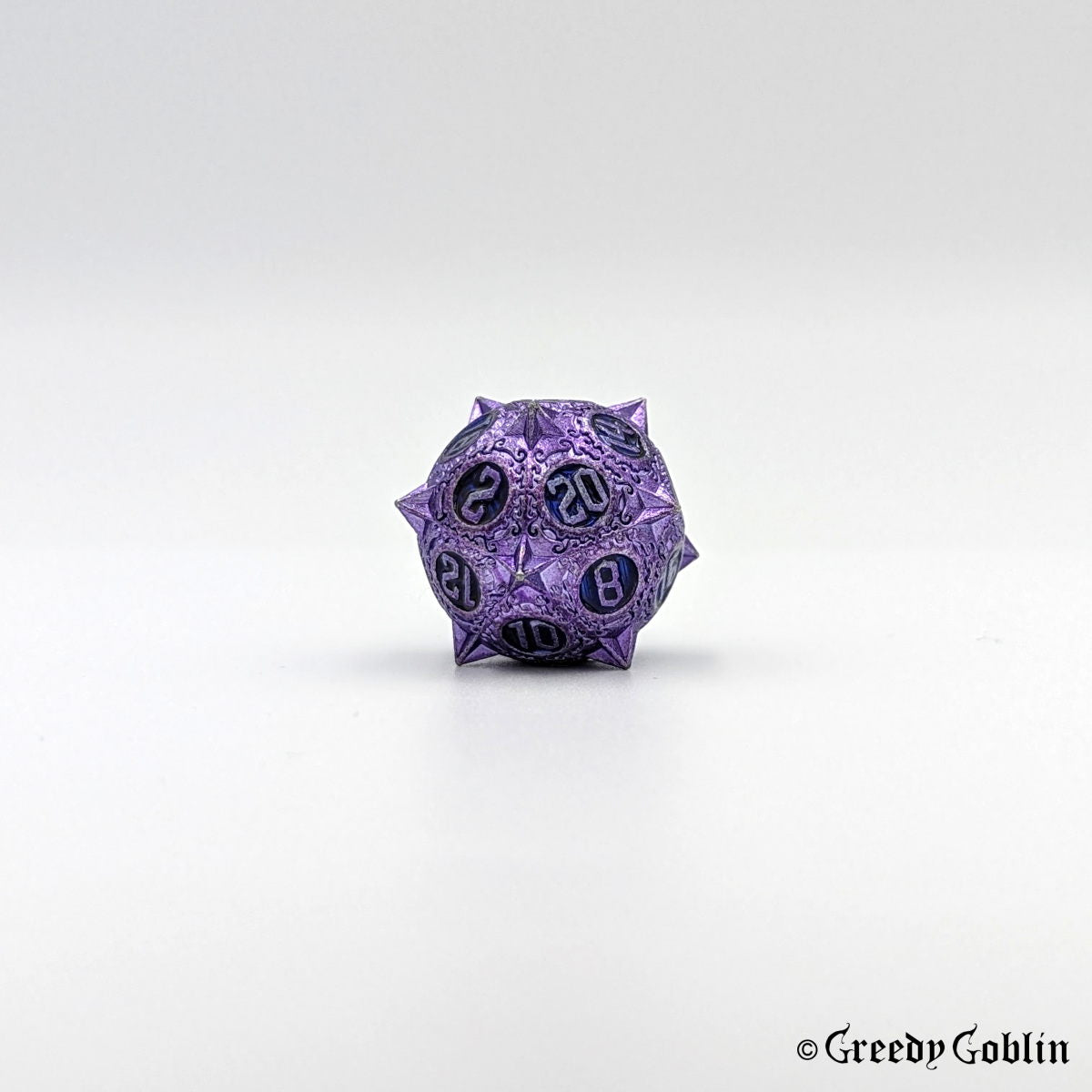 Metal D20 from DnD dice set with sharp edges and purple finish. The engravings behind the numbers are blue.