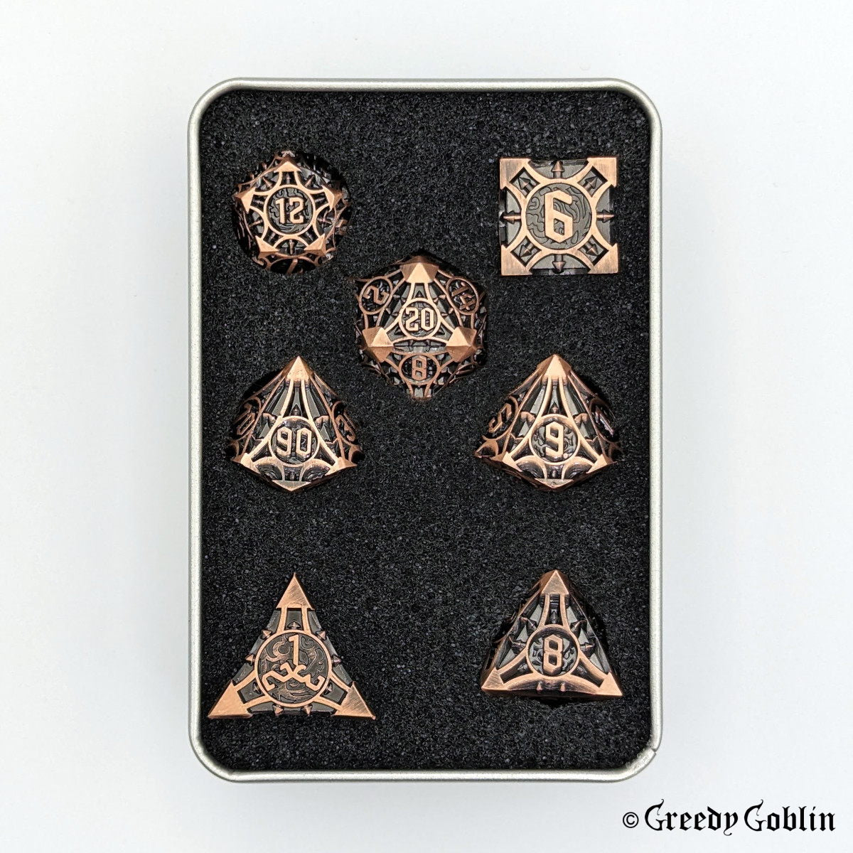 Copper metal Polydice set (D100, D8, D12, D10, D6, D20, D4) with black engravings, in a metal tin box.