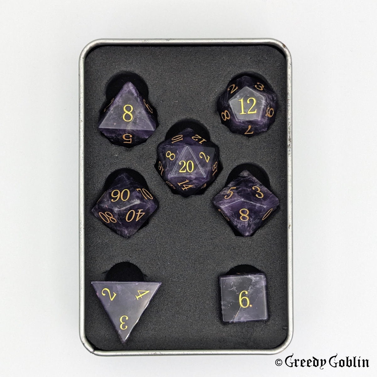 Amethyst gemstone Polydice set (D100, D8, D12, D10, D6, D20, D4) with gold numbers, in a tin box.