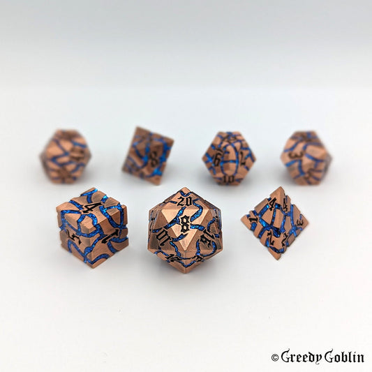 A set of seven copper metal DnD dice that has blue mica veins and black numbers displayed on a white background.