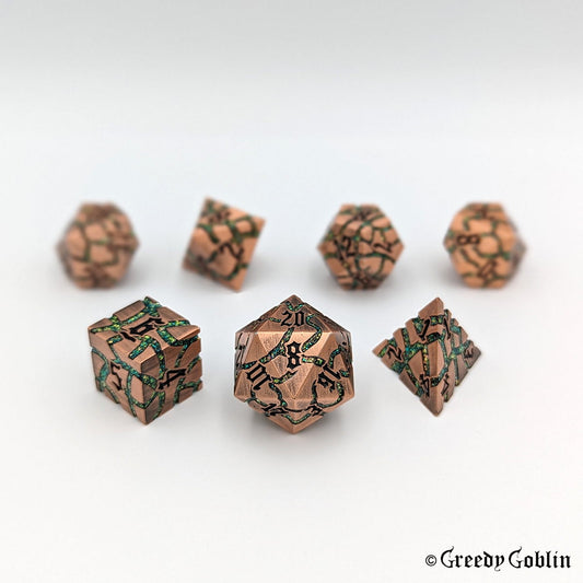 A set of seven copper metal DnD dice with green mica veins and black numbers displayed on a white background.