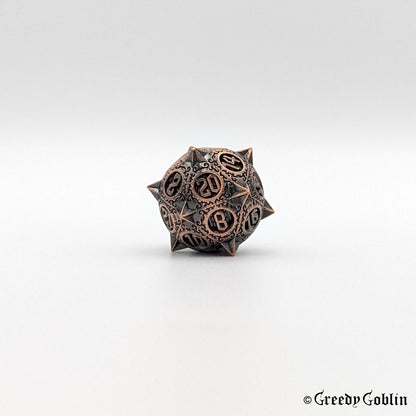 Metal D20 from DnD dice set with sharp edges and copper finish.