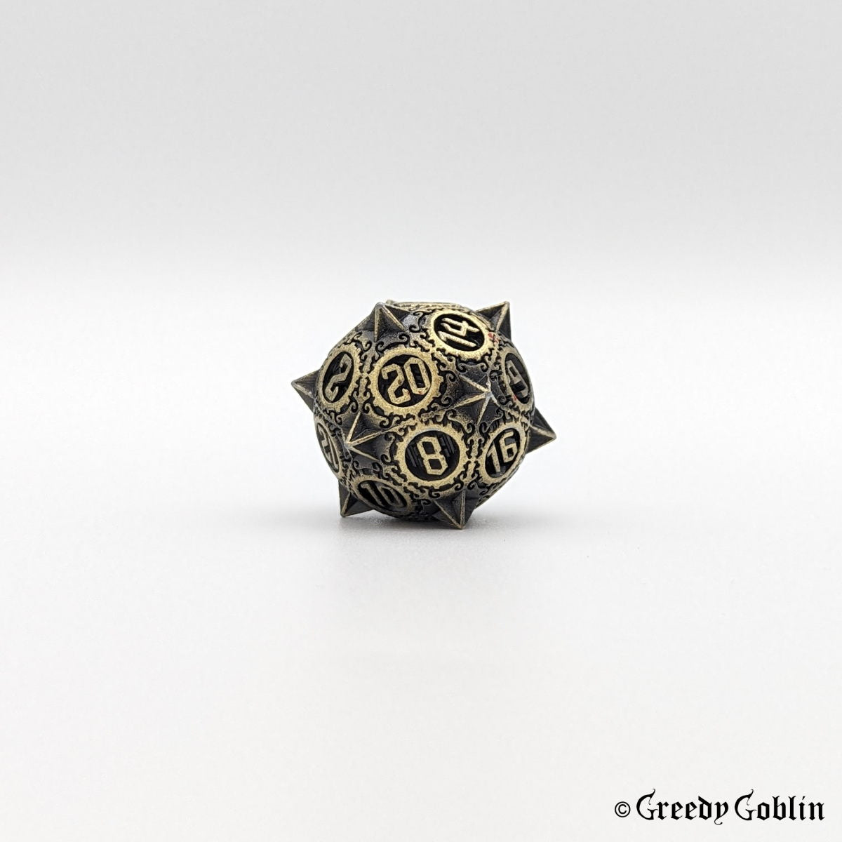 Metal D20 from DnD dice set with sharp edges and bronze finish.