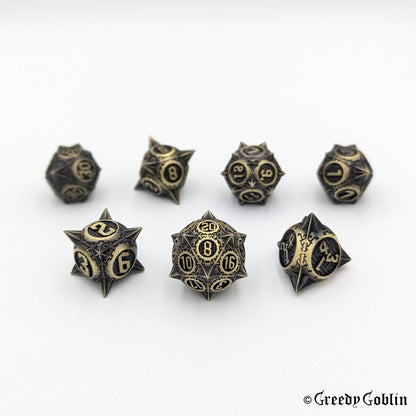 Metal DnD dice set (D4, D6, D8, D12, D20, 2x D10) with sharp edges and bronze finish.