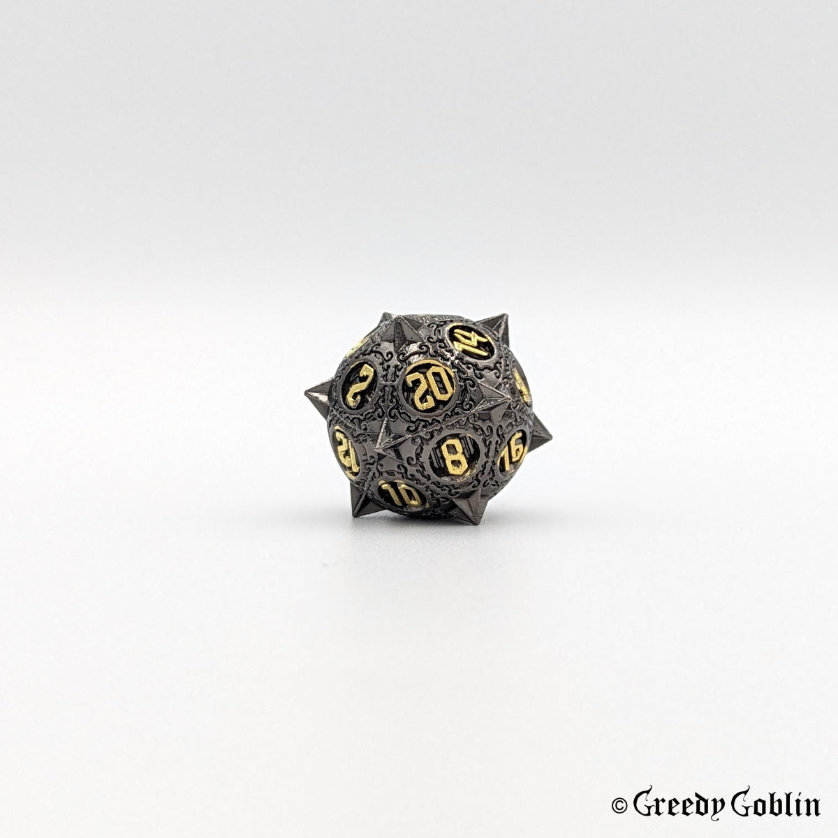 Gunmetal D20 with sharp edges and gold numbers from DnD dice set.