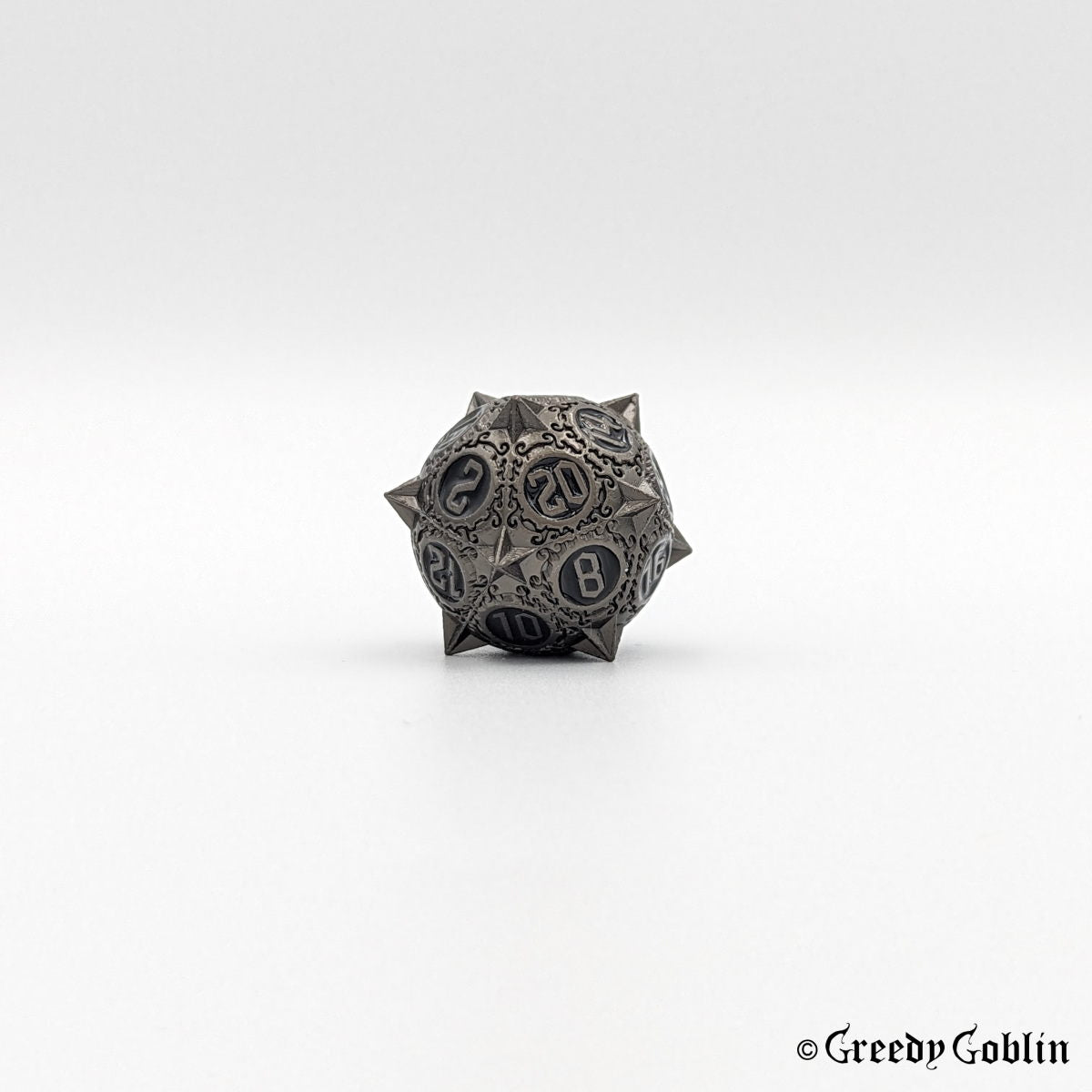 Metal D20 from DnD dice set with sharp edges and gunmetal finish.