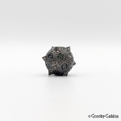 Metal D20 from DnD dice set with sharp edges and gunmetal finish. The engravings behind the numbers are dark green.