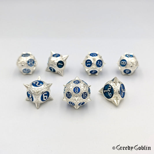 Metal DnD dice set (D4, D6, D8, D12, D20, 2x D10) with sharp edges and silver finish. The engravings behind the numbers are blue.