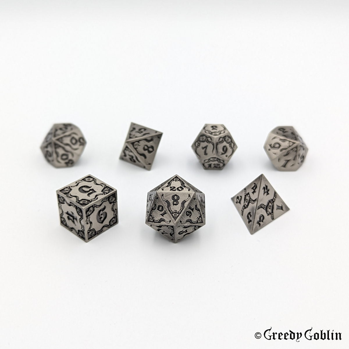 Cthulhu-themed DnD dice set in brushed metal with black engravings and numbers (D4, D6, D8, D12, D20, 2x D10).