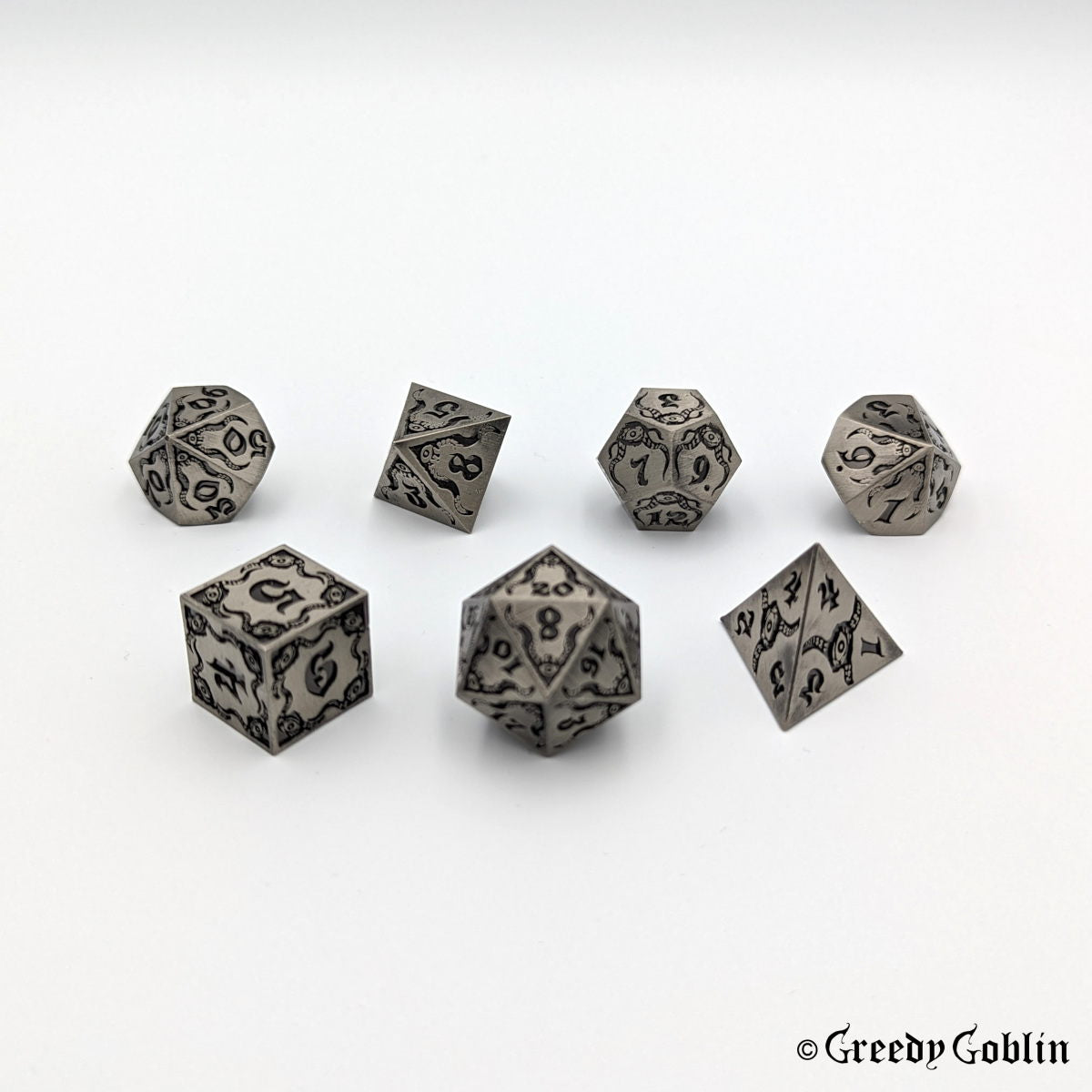 Cthulhu-themed DnD dice set in brushed metal with black engravings and numbers (D4, D6, D8, D12, D20, 2x D10).