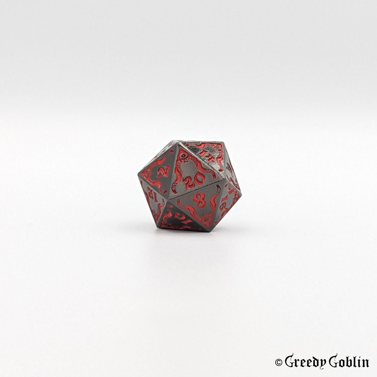 Gunmetal Cthulhu D20 from DnD dice set, with red engravings and numbers.