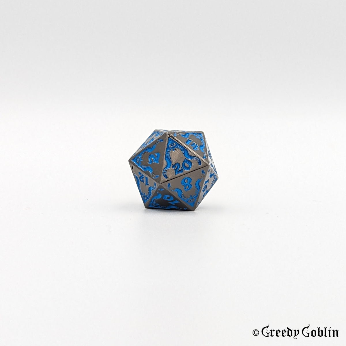 Gunmetal Cthulhu D20 from DnD dice set, with blue engravings and numbers.