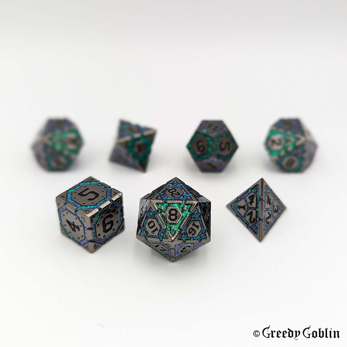 A set of seven polyhedral dice with intricate patterns, including a d20, d12, d10, d100, d8, d6, and d4, arranged on a plain white background.